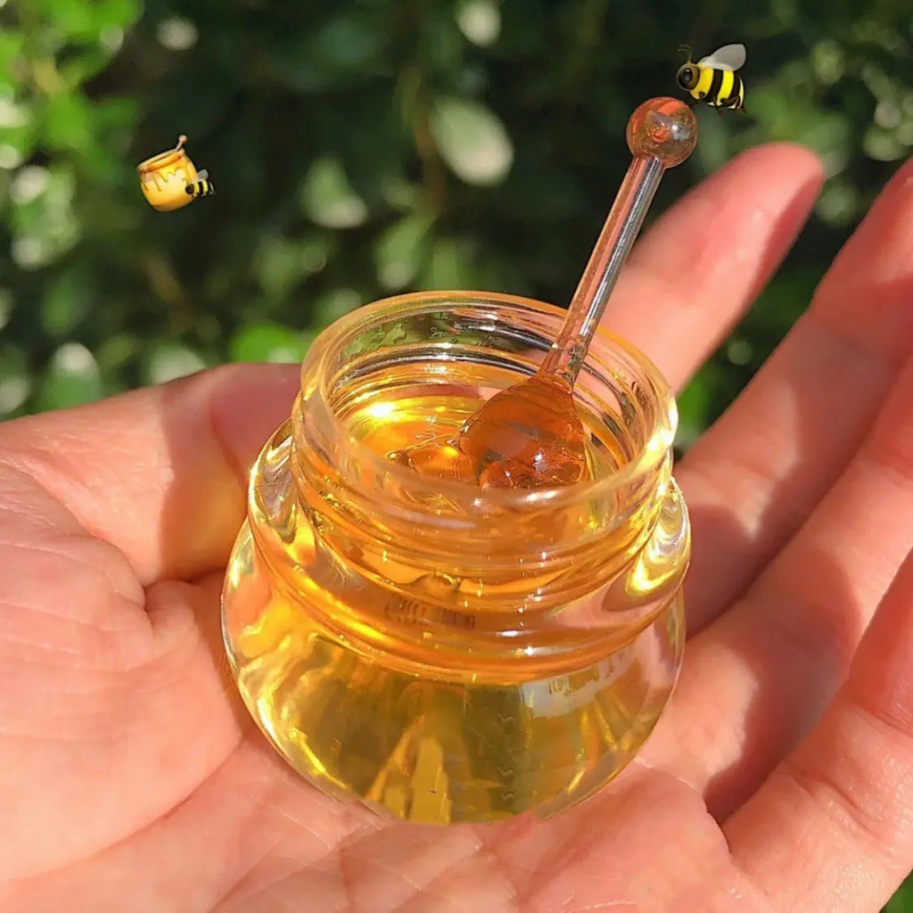 Little honey pot lip mask in a hand, showcasing its nourishing moisturizing properties for healthy lips.